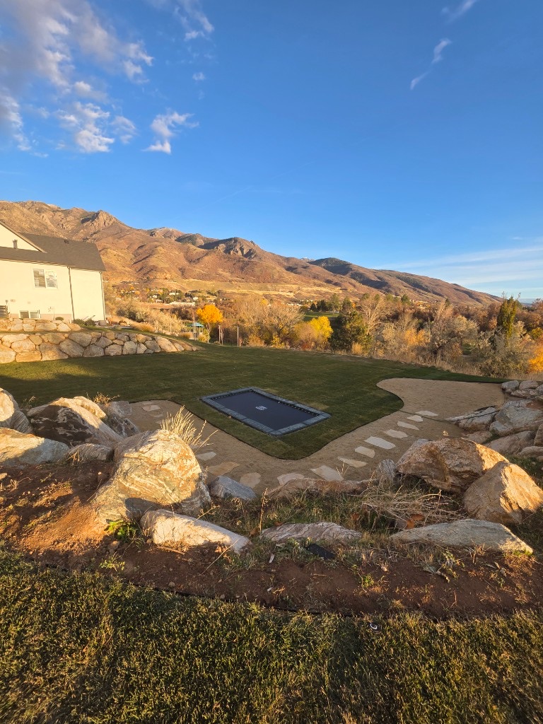 Boulder retaining wall with mountain view in Utah by Sol Scapes