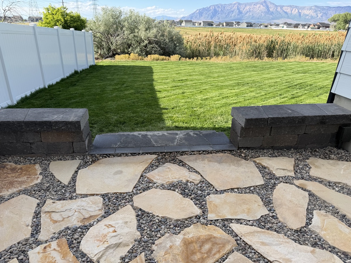 Flagstone path with pebble fill and block retaining wall with mountain views