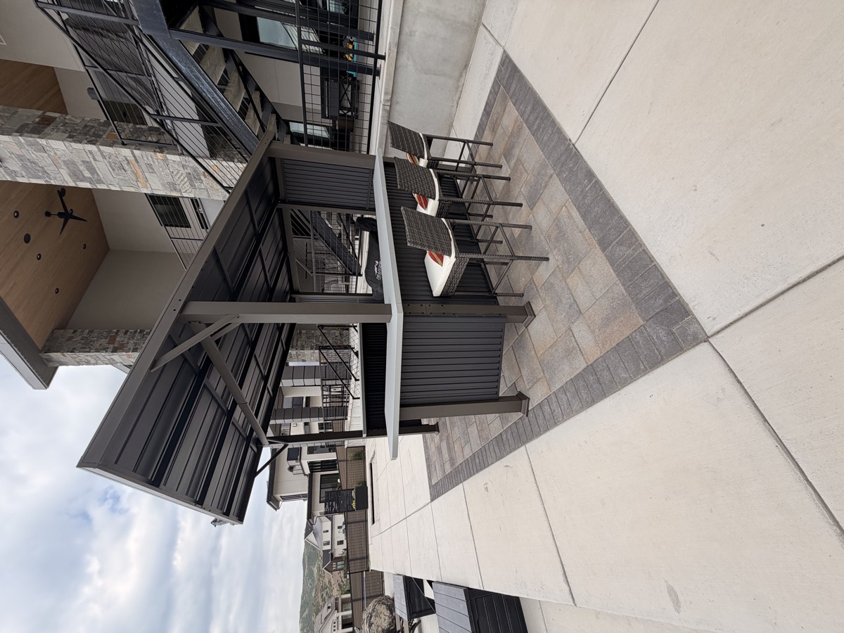 Outdoor kitchen with paver patio and pergola bar area