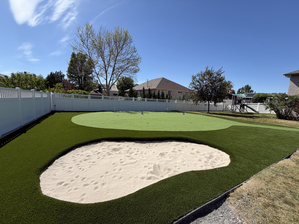 Custom putting green with sand trap and multiple holes