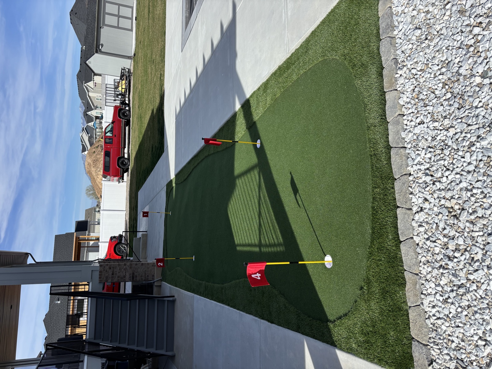 Backyard putting green installation with flags — Sol Scapes Utah