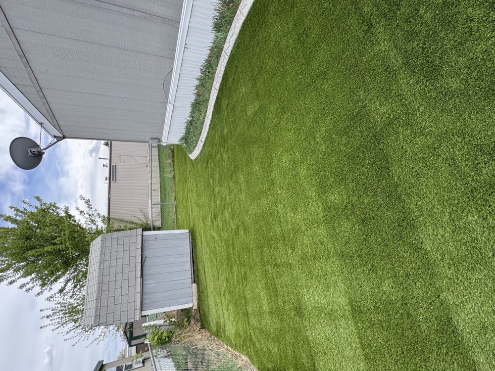 Lush artificial turf backyard in Utah showing long-lasting quality