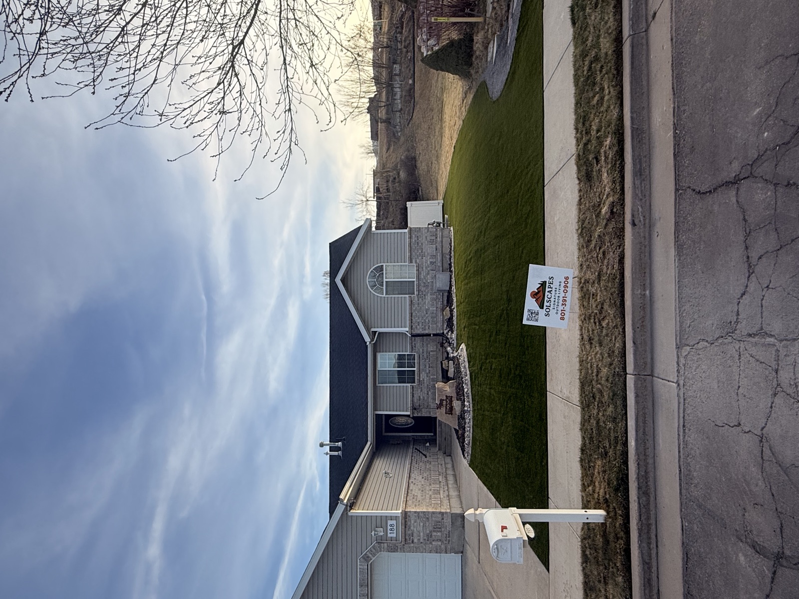 Sol Scapes artificial turf installation with company yard sign in Utah